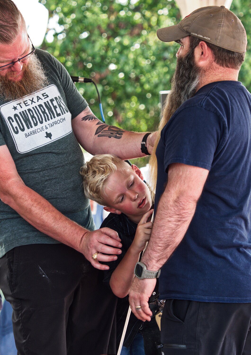Jason Herring get some assistance from son Kyle measuring hair lengths for the beard master competition. [see so many more sesquicentennial spring fling photos]